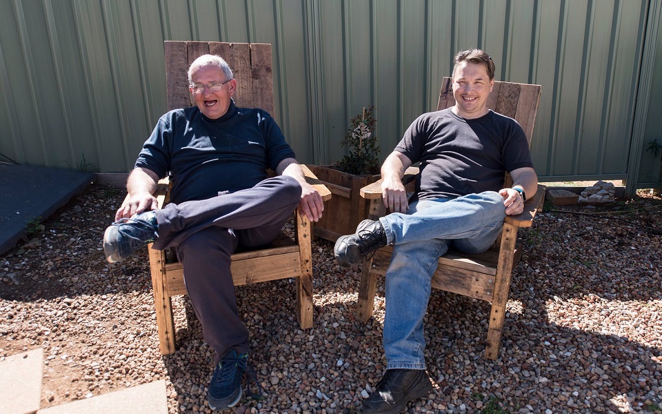 Andrew with the furniture he made